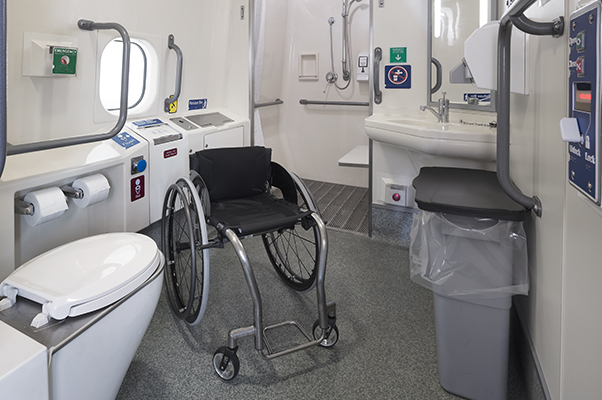 Accessible toilet and shower room. showing a wheelchair in the room.