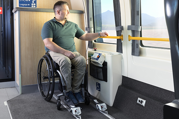 A customer sits in their wheelchair in the Carriage E Accessible Wheelchair Space.