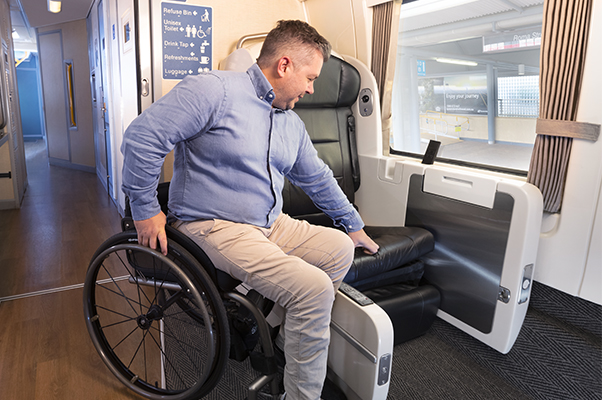 A customer transferring themselves from a wheelchair to an Accessible RailBed.