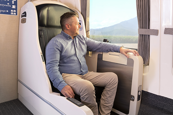 A customer sitting in an accessible RailBed daytime configuration with seat.